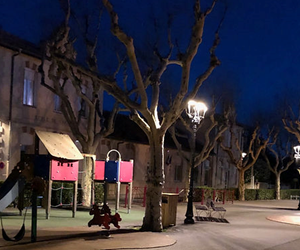 Photo le soir d'une air de jeux avec des lampadaires allumés