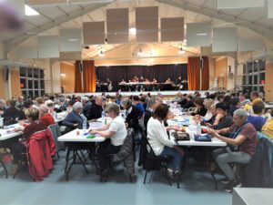 Photo dans une grande salle de personnes assises en train de faire un lotto